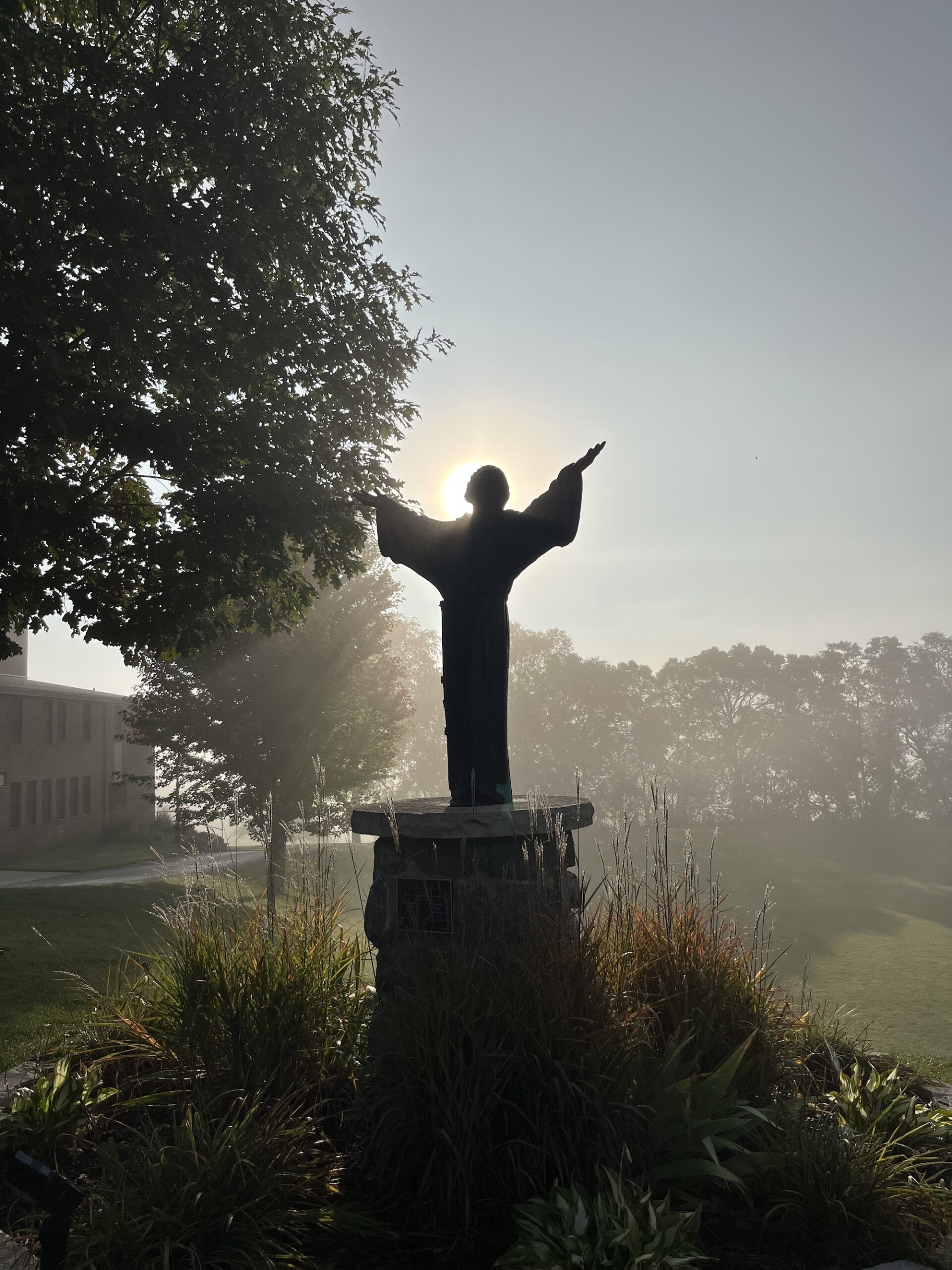 Statue of St. Lawrence with sun shining from behind